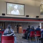 International Women's Day 2022, audience & projected screen of C. Kemal Nance's slideshow